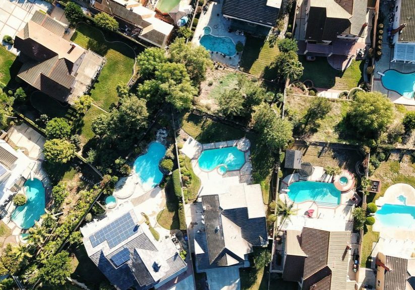 aerial view of houses with pools